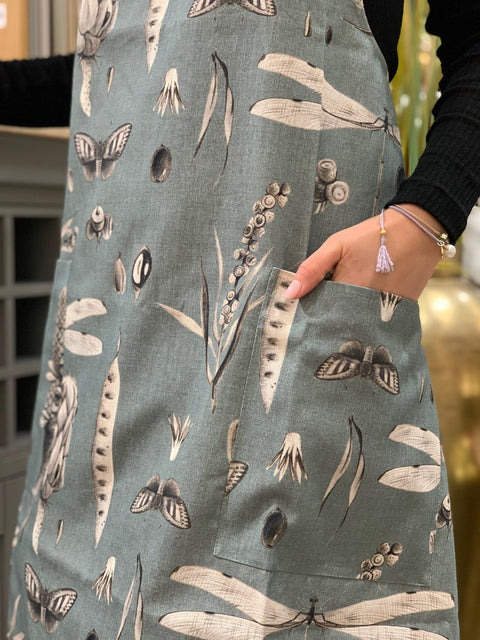 3. Close-up of Seeds Aqua print apron pocket detail, showing botanical design on cotton fabric