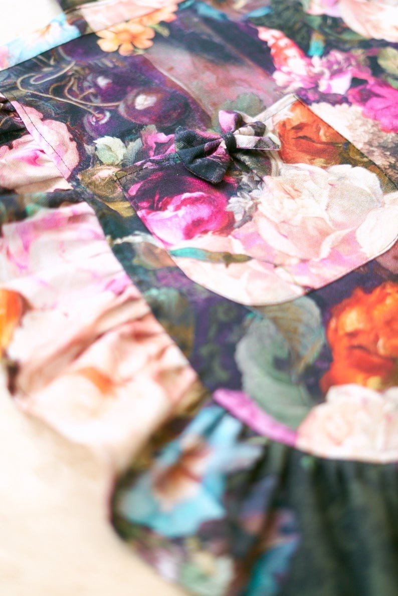 3. Close-up of floral apron fabric highlighting colorful print and ruffle detail
