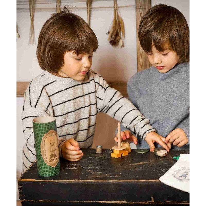 1. Two children assembling LALA Stick Figure Puzzle on a rustic table