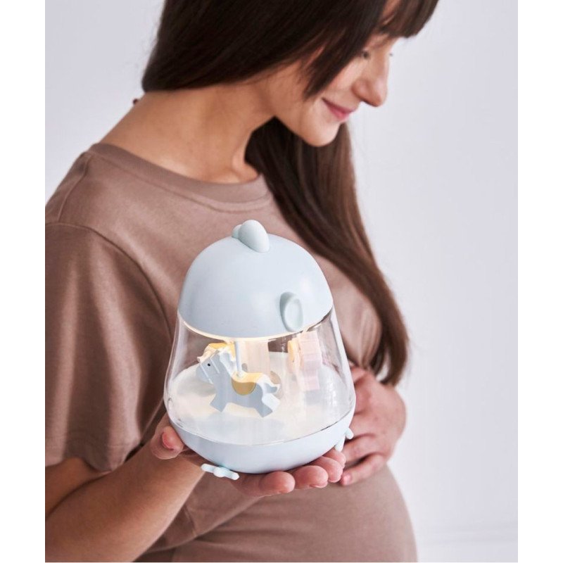 1. Pregnant woman holding blue Rabbit & Friends lamp with carousel
