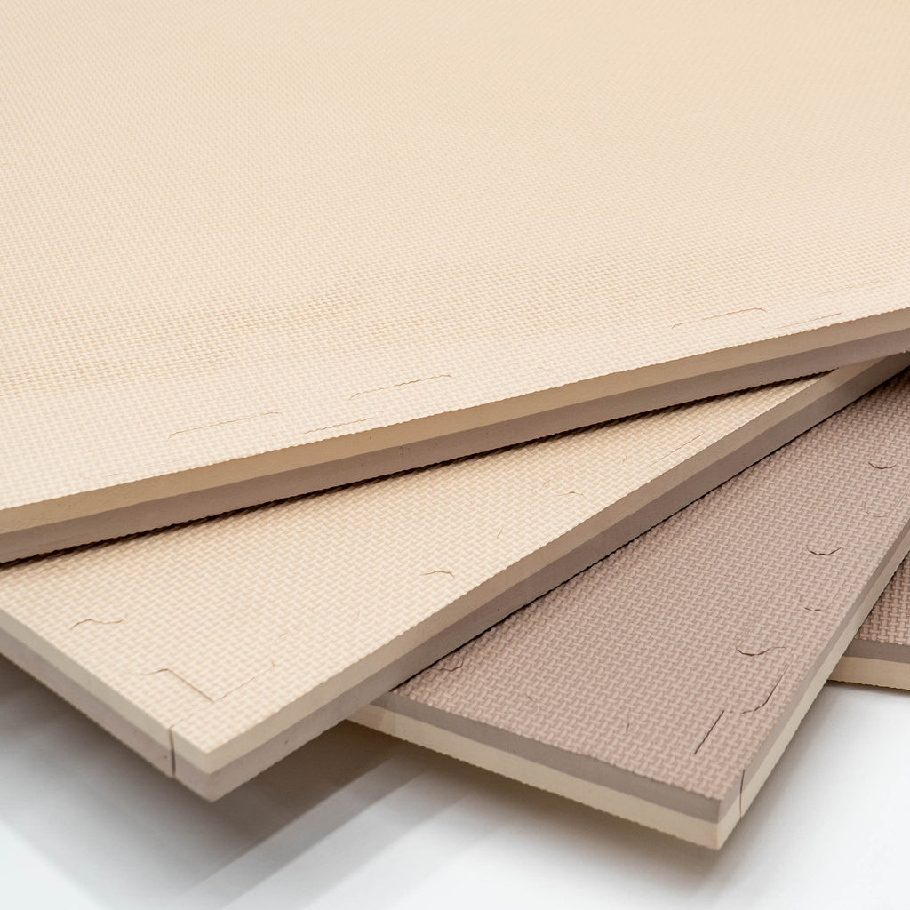 4. Stack of beige and dark beige foam puzzle mats showing thickness and texture