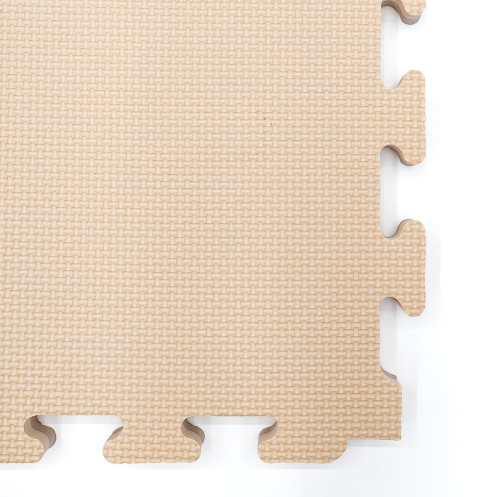 6. Close-up of interlocking edge of beige foam puzzle mat showing texture
