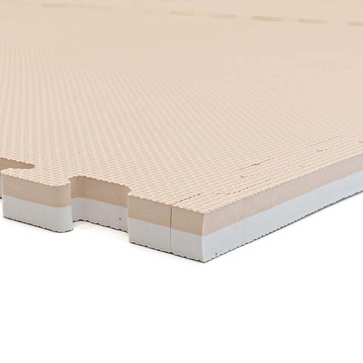 8. Side view of beige foam puzzle mat showing thickness and interlocking edge
