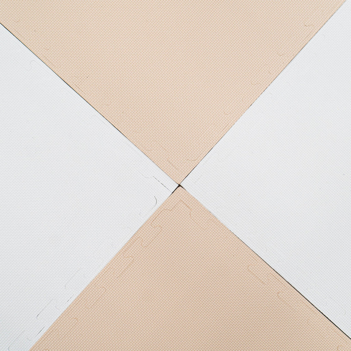 7. Close-up of beige and white foam puzzle mats connected at the corners