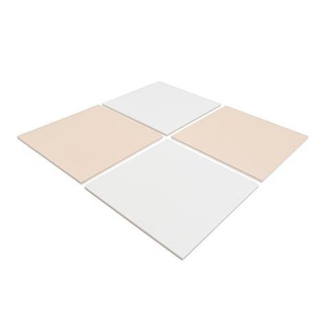 1. Four beige and white foam puzzle mats arranged in a square on a white background