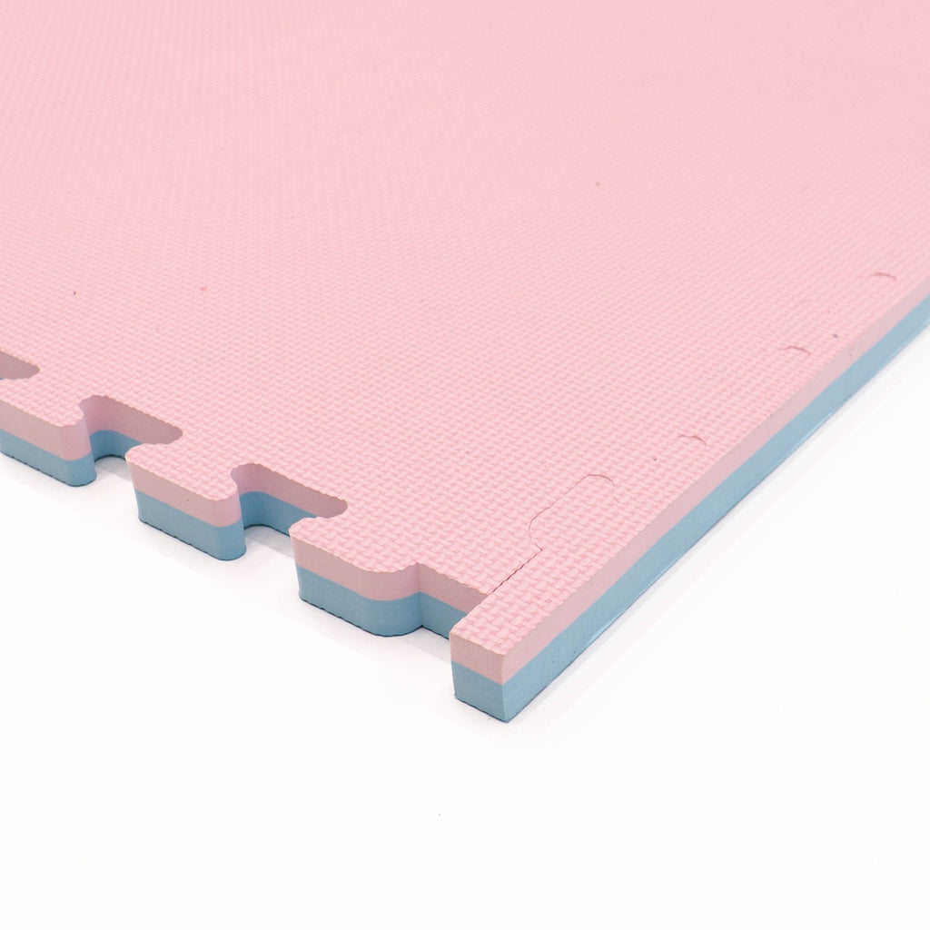 9. Close-up of pink foam puzzle mat edge, showing thickness and interlocking design