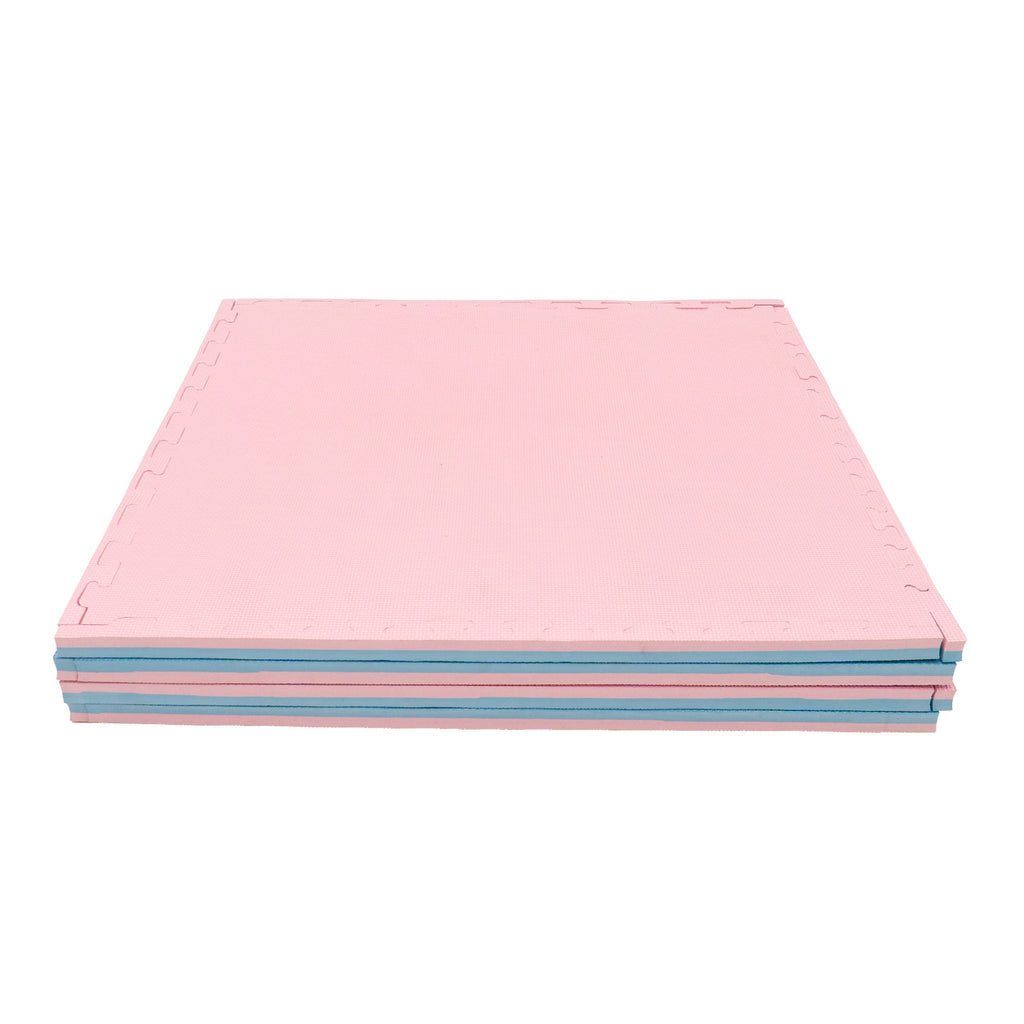 10. Stack of large foam puzzle mats in baby pink and baby blue, highlighting thickness