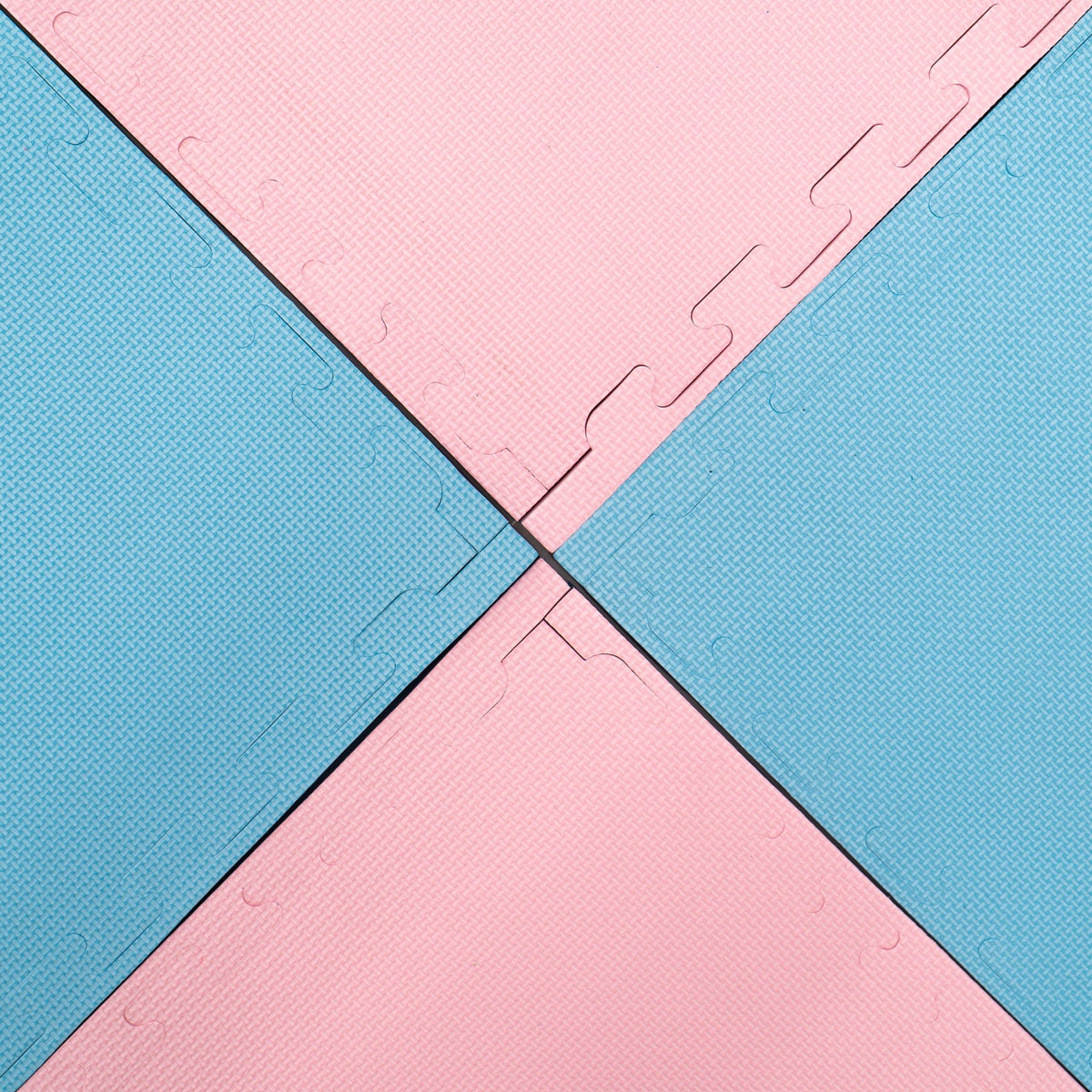 11. Close-up of interlocked baby pink and baby blue foam puzzle mats, showing texture
