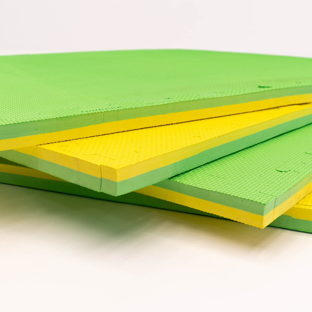 4. Stack of IGLU foam puzzle mats in spring green and yellow showing thickness and layers