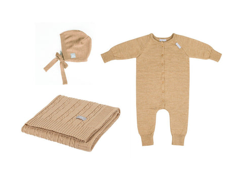 2. Flat lay of beige merino wool baby gift set including romper, bonnet, and braided blanket