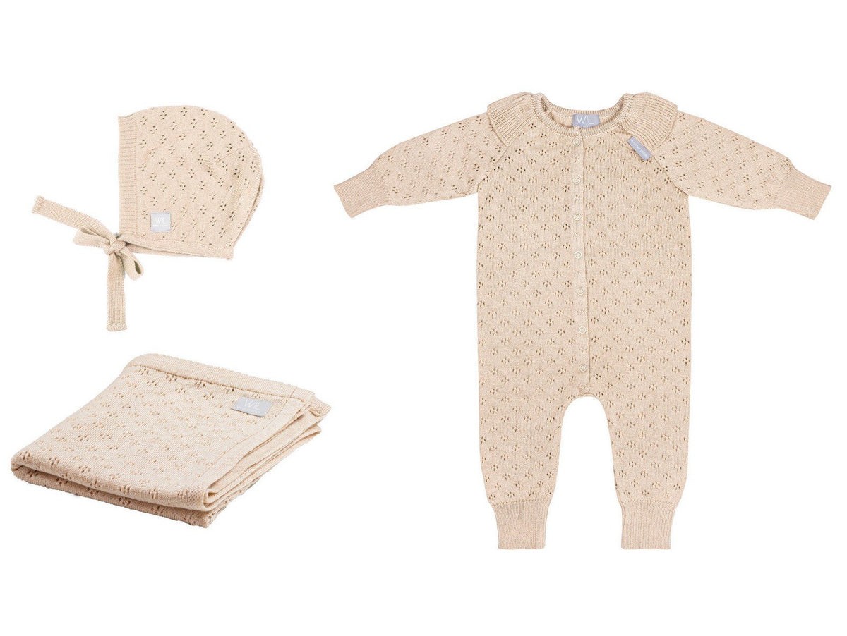 8. Flat lay of beige merino wool romper, bonnet, and blanket set