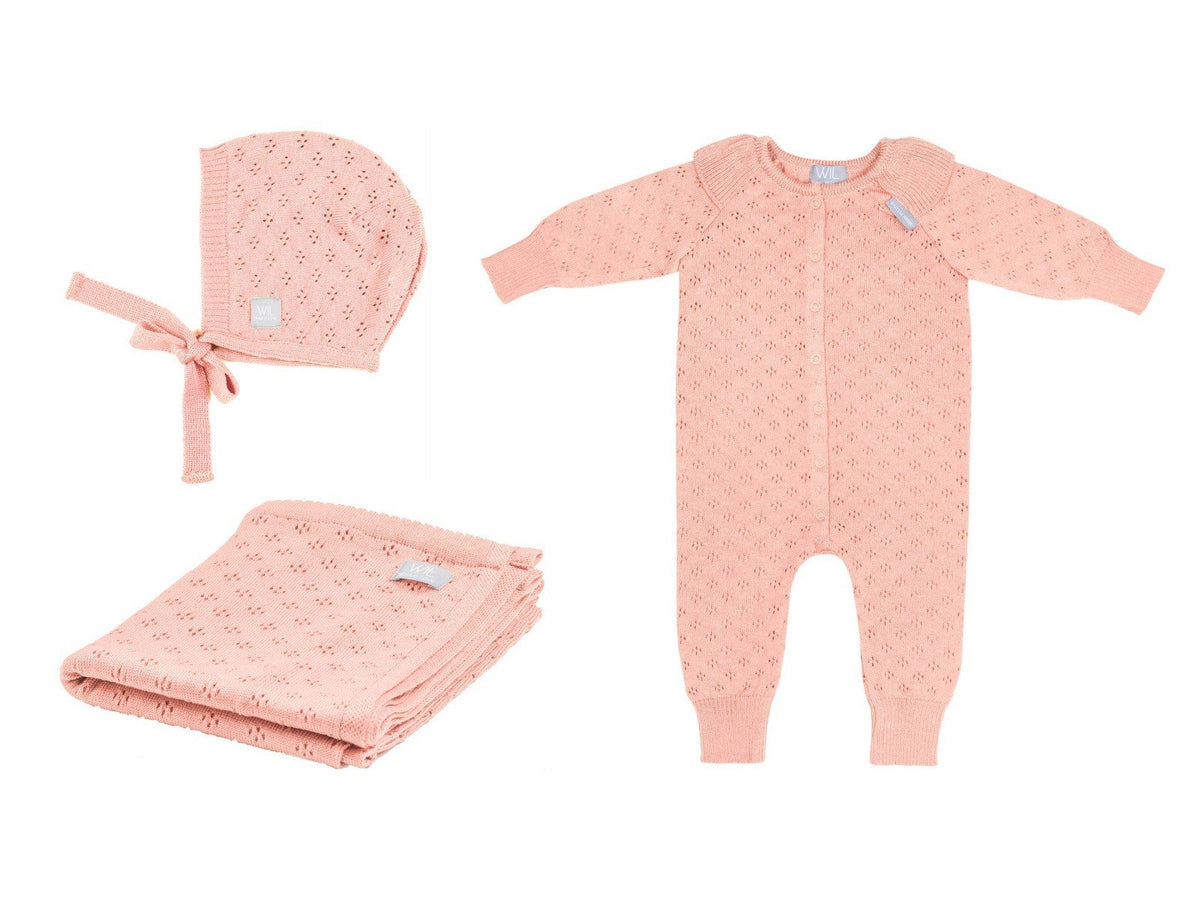 10. Flat lay of pink merino wool romper, bonnet, and blanket set