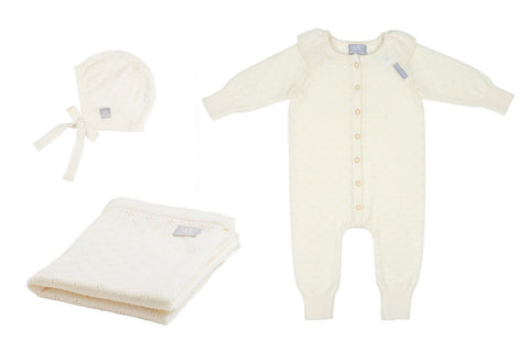 4. Flat lay of cream merino wool romper, bonnet, and blanket set