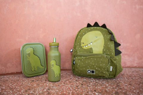 1. Green dinosaur-themed lunch box, bottle, and backpack set against a pink wall