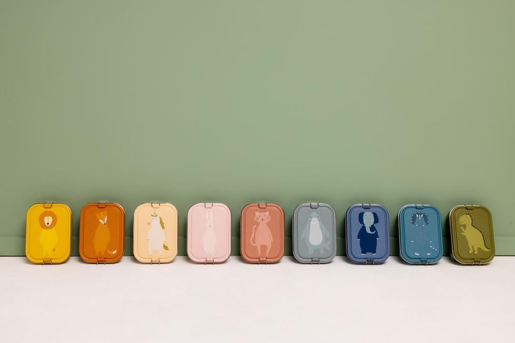 2. Row of colorful animal-themed lunch boxes including Mr. Lion and Mr. Fox against green background