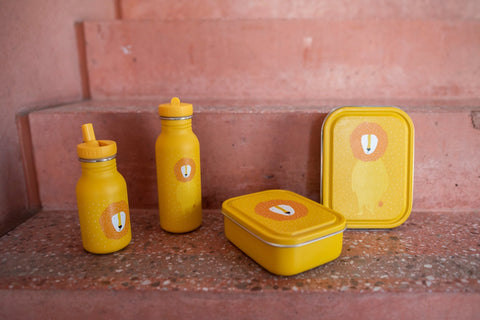 1. Yellow Mr. Lion lunch box and matching bottles on stone steps