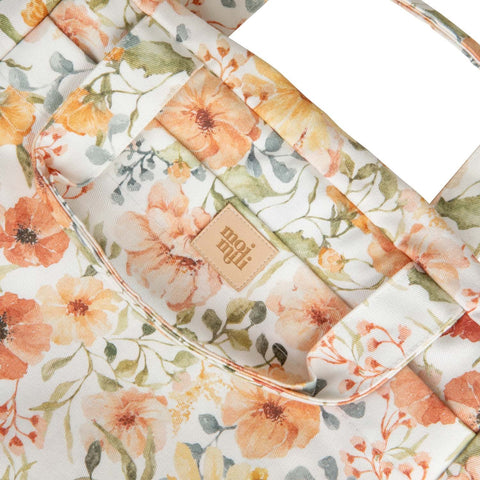 3. Close-up of Moi Mili floral makeup bag showing fabric texture and brand logo