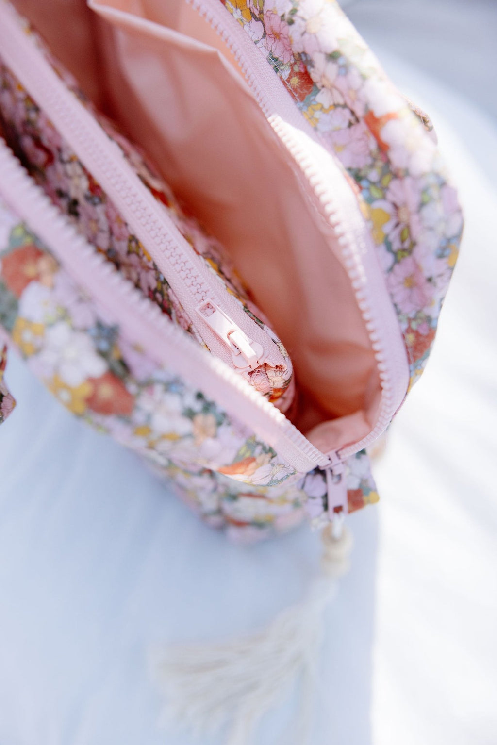 3. Close-up of Moi Mili makeup bag interior showing pink waterproof lining and zipper