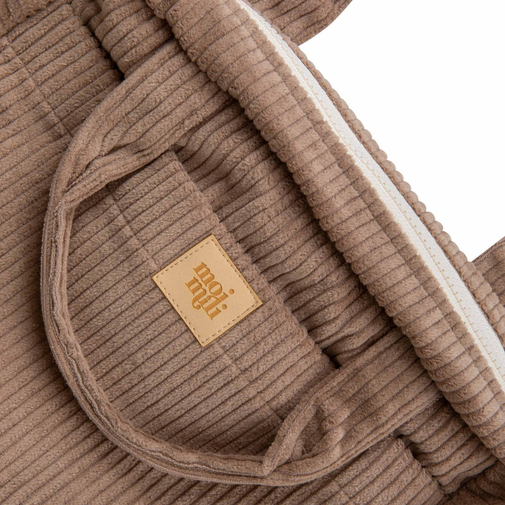 3. Close-up of latte-colored makeup bag showing Moi Mili logo and ribbed cotton texture