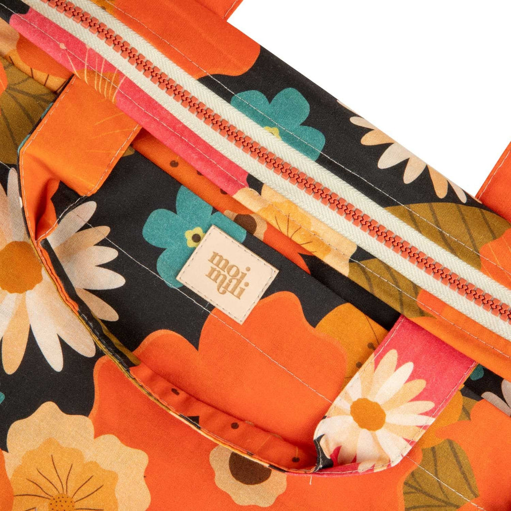 8. Close-up of floral fabric and moi mili logo on makeup bag