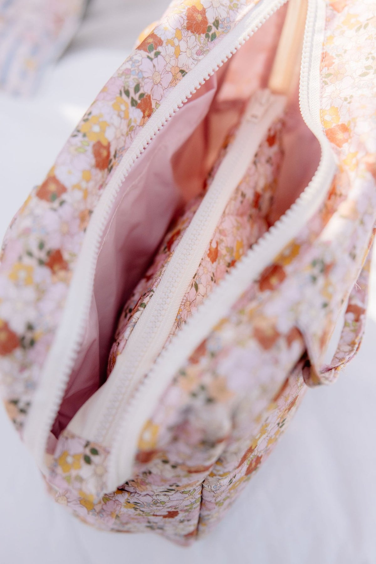 3. Close-up of open zipper on Moi Mili floral makeup bag showing pink interior