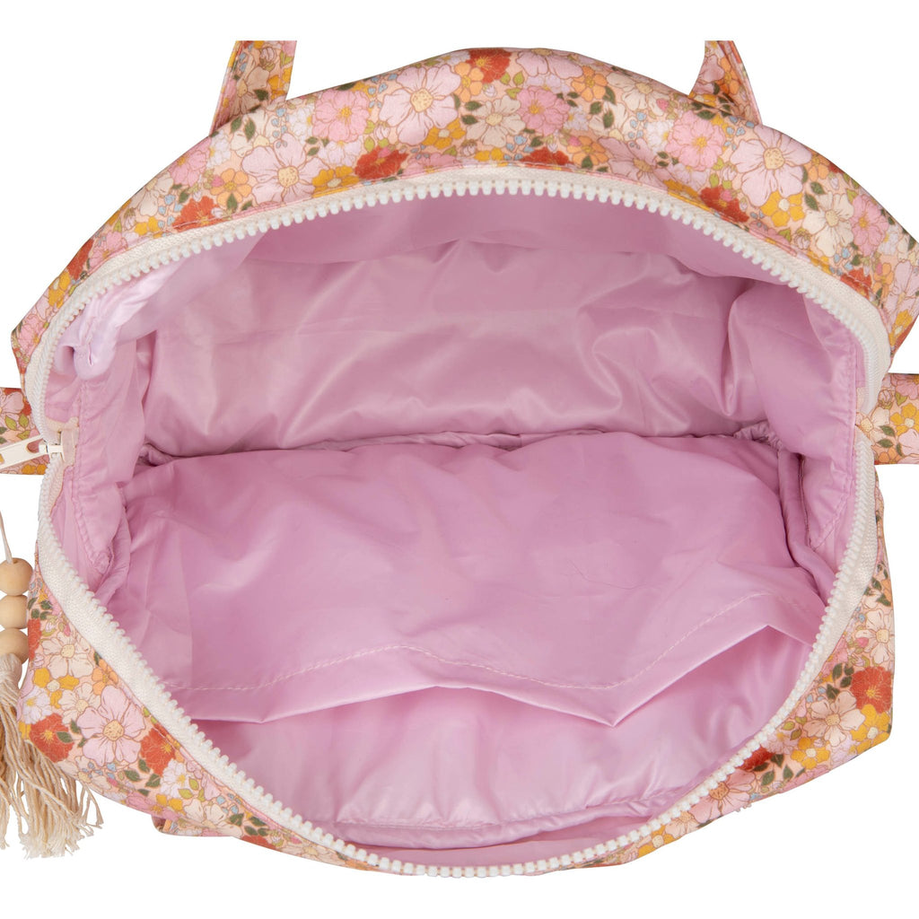 3. Interior view of Moi Mili large makeup bag with pink waterproof lining and open zipper