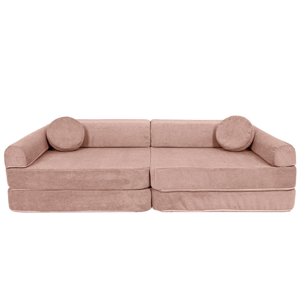 2. Large pink modular sofa for kids in slimcord corduroy with two round cushions, shown in a studio setting