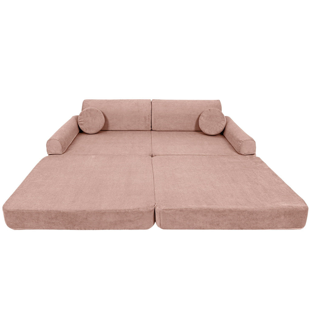 2. Large pink modular sofa for kids in slimcord corduroy with two round cushions, shown in a studio setting