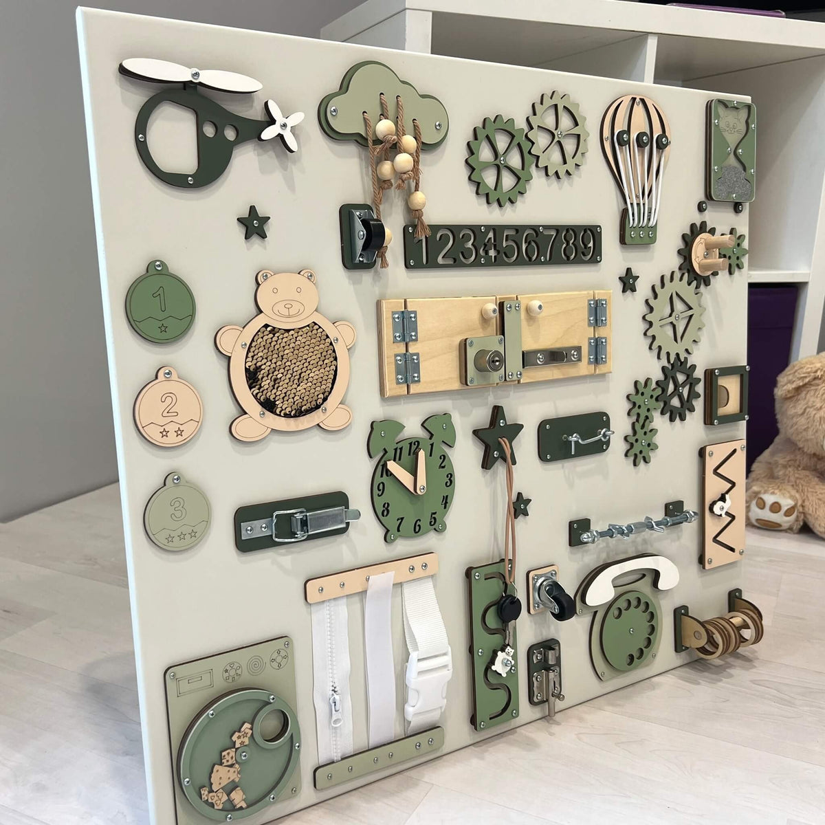 4. Side view of Montessori busy board with green and beige elements, showcasing interactive features for children's development.