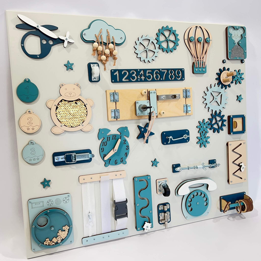 3. Close-up of Montessori busy board with blue and beige elements, highlighting various interactive features for children's play.