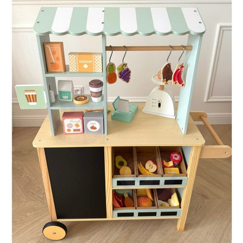1. Child playing with Woopie Green wooden food truck stand in a room setting