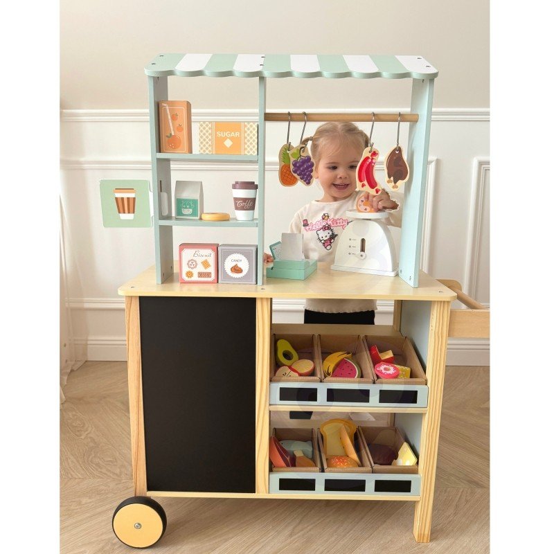 14. Child playing with Woopie Green wooden food truck stand, front view