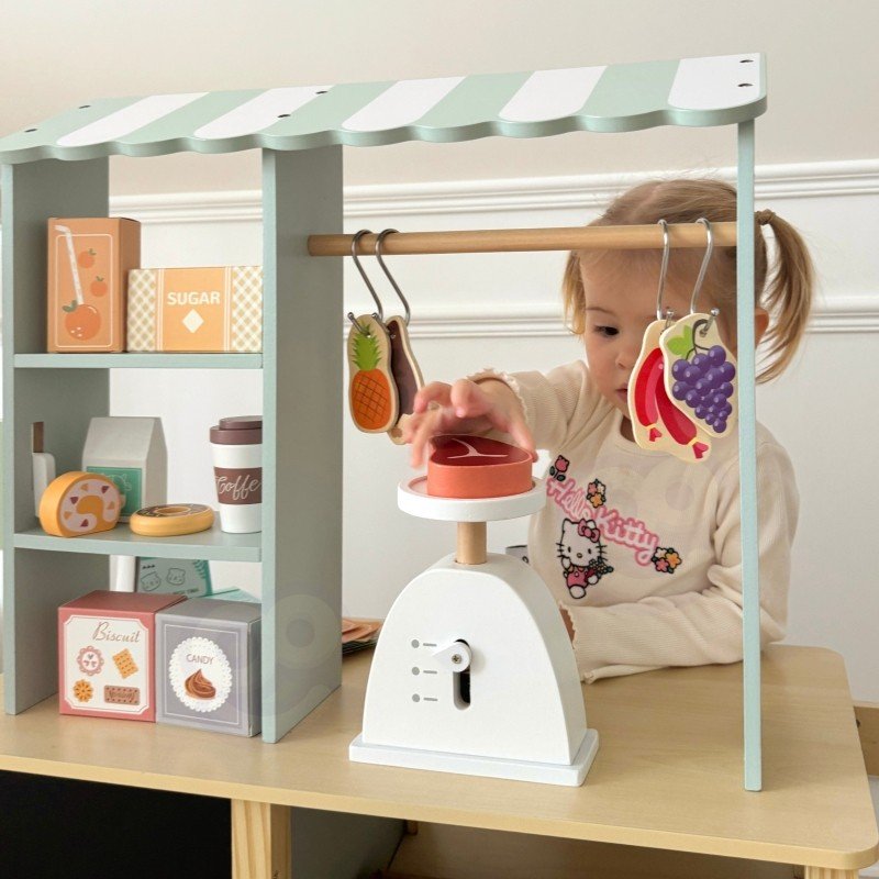 17. Child using scale on Woopie Green wooden food truck stand