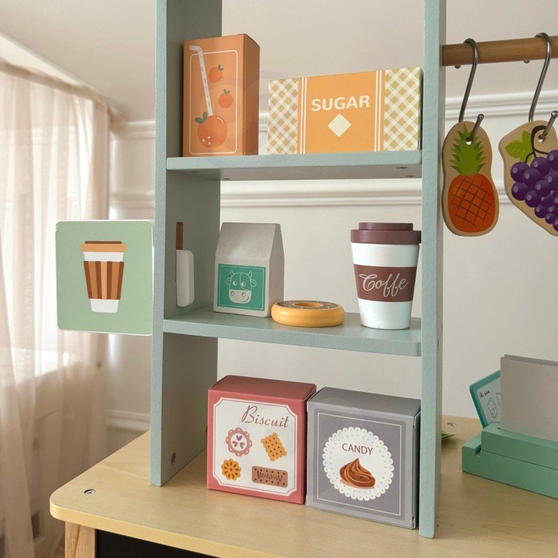 2. Close-up of shelves with play food items on Woopie Green wooden food truck