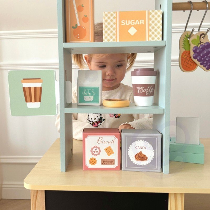 15. Child interacting with shelves on Woopie Green wooden food truck stand