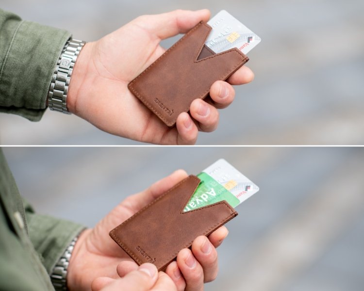 2. Person holding brown slim card protector wallet with cards partially visible