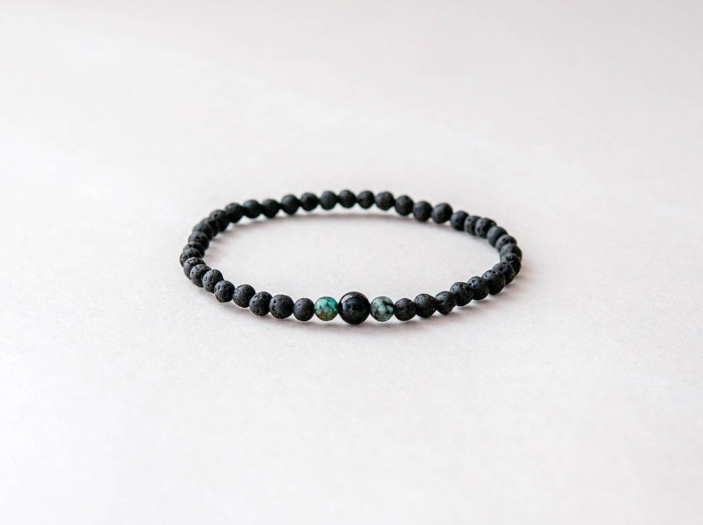 2. Studio shot of men's lava bracelet featuring 4mm onyx and turquoise beads by Canary Lava