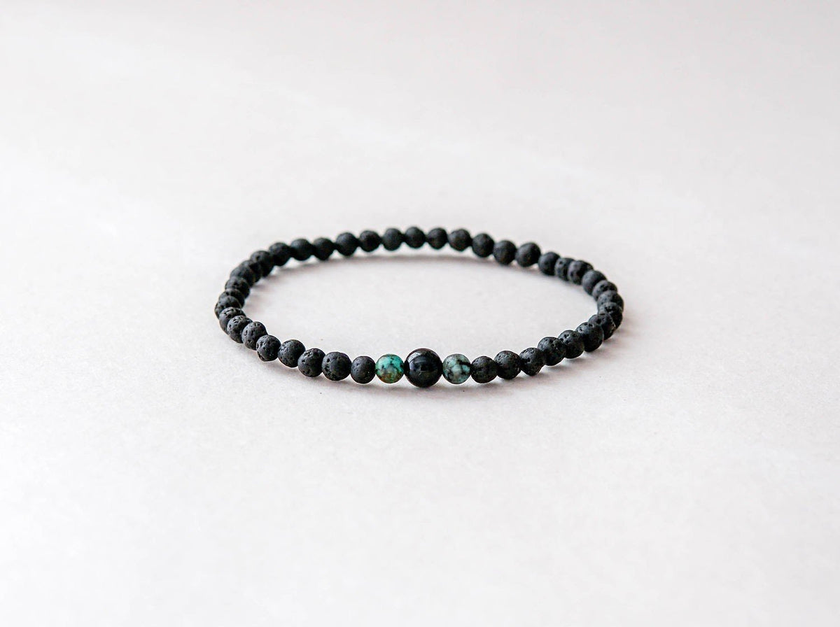 2. Studio shot of men's lava bracelet featuring 4mm onyx and turquoise beads by Canary Lava