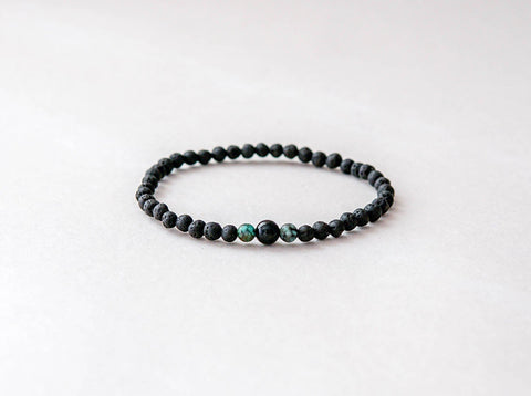 2. Studio shot of men's lava bracelet featuring 4mm onyx and turquoise beads by Canary Lava