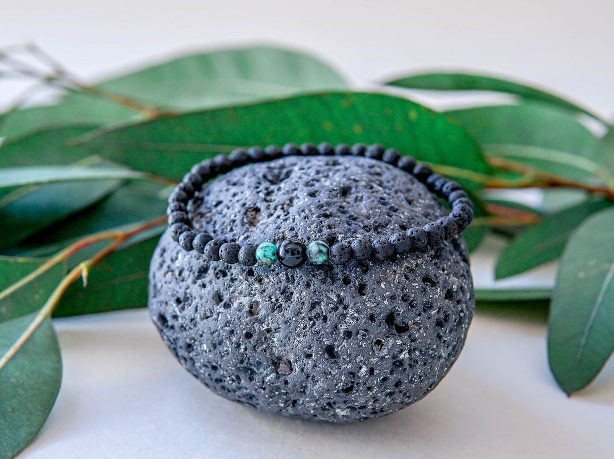 5. Men's lava bracelet with onyx and turquoise beads by Canary Lava, styled on volcanic rock