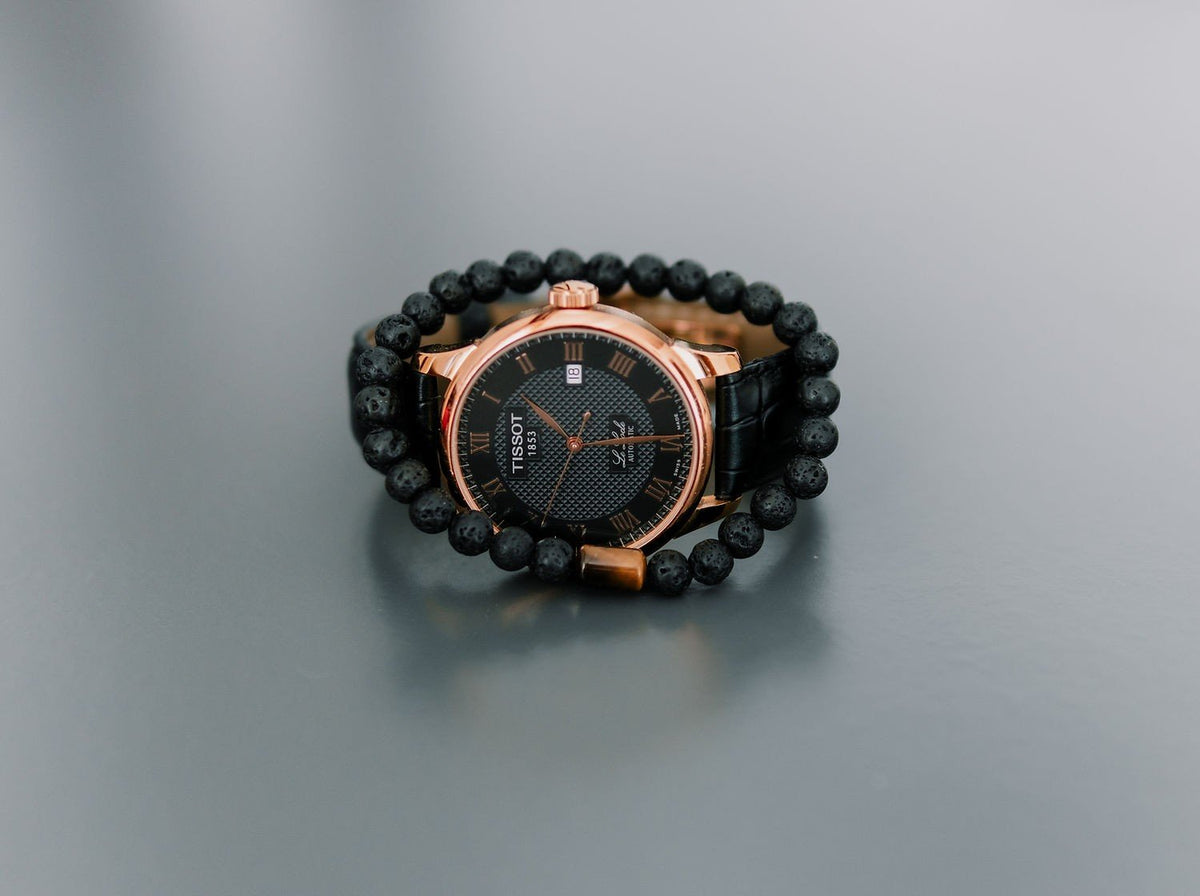 3. Men's Canary Lava bracelet with tiger eye bead styled with a luxury watch