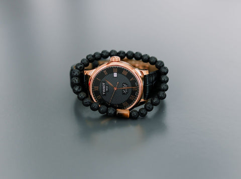 3. Men's Canary Lava bracelet with tiger eye bead styled with a luxury watch