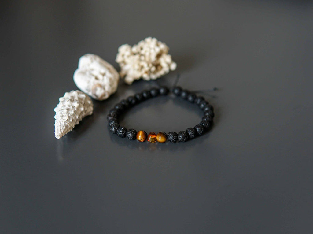 4. Lava Stone Bracelet with Amber and Tiger Eye by Canary Lava, styled with seashells