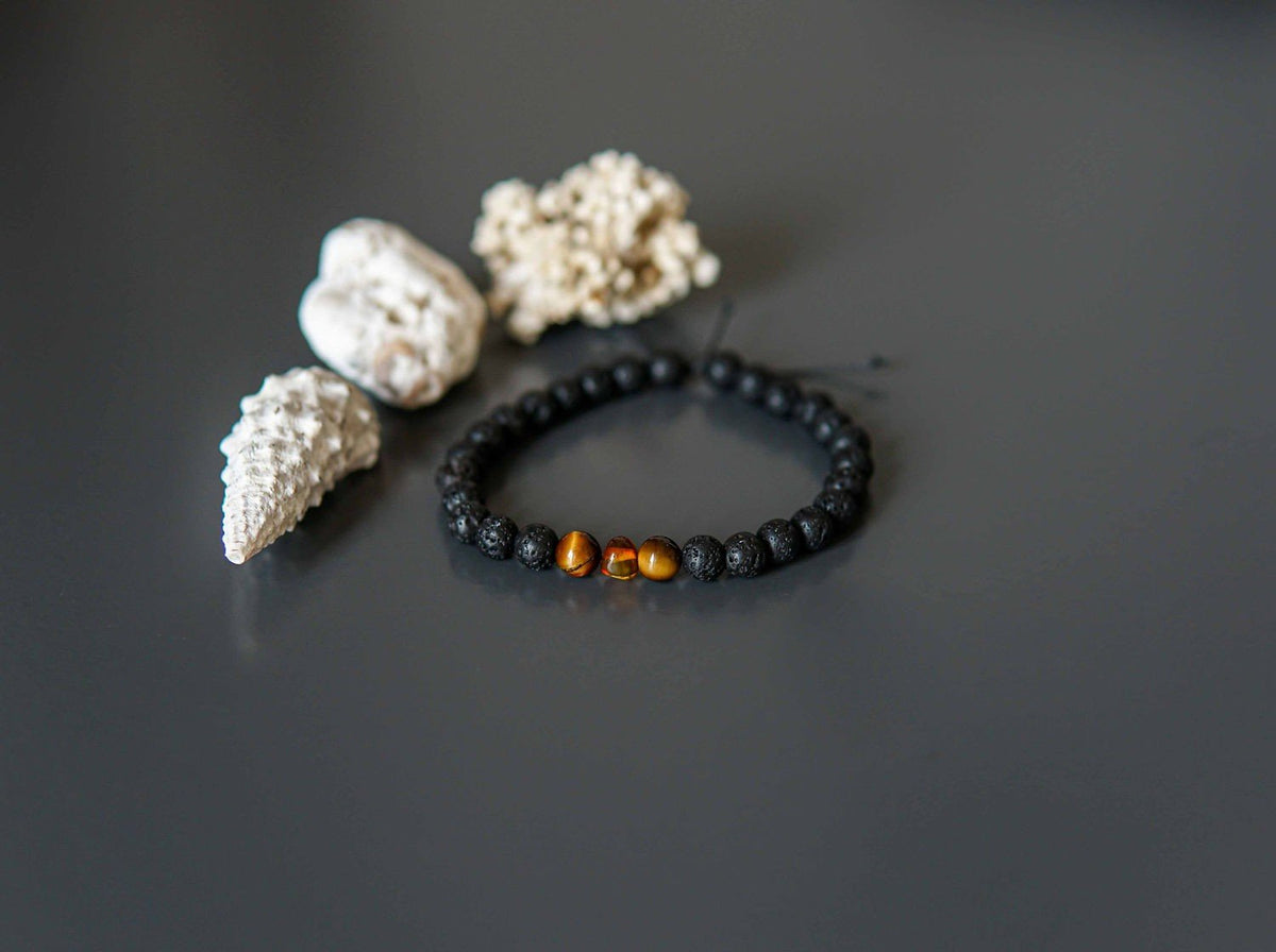 4. Lava Stone Bracelet with Amber and Tiger Eye by Canary Lava, styled with seashells