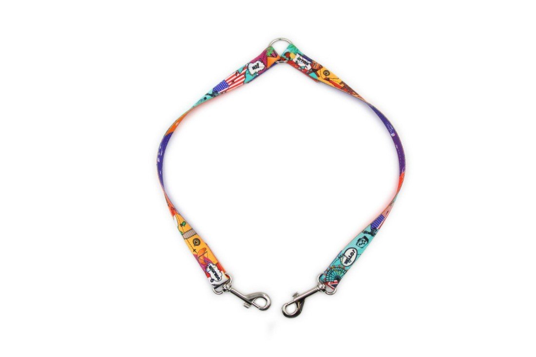 5. Flat lay of Matteo leash splitter with colorful travel-themed design and metal clips