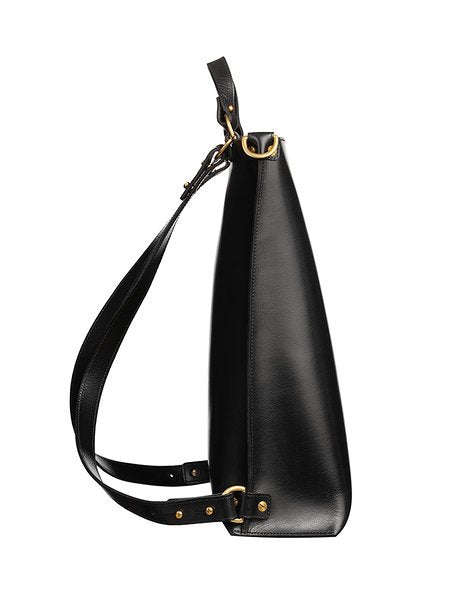 6. Side view of black leather backpack by Stella Soomlais with gold hardware and adjustable straps