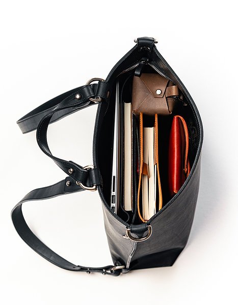 8. Interior view of black leather backpack by Stella Soomlais with laptop and accessories inside