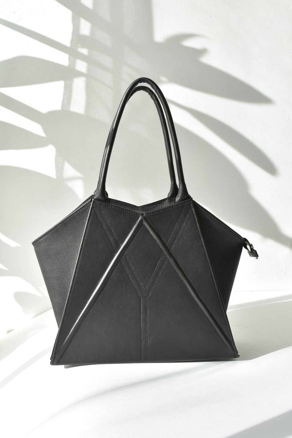 5. Studio shot of Gerda Retter Design Leather Handbag Nova in black, showcasing geometric design and handles
