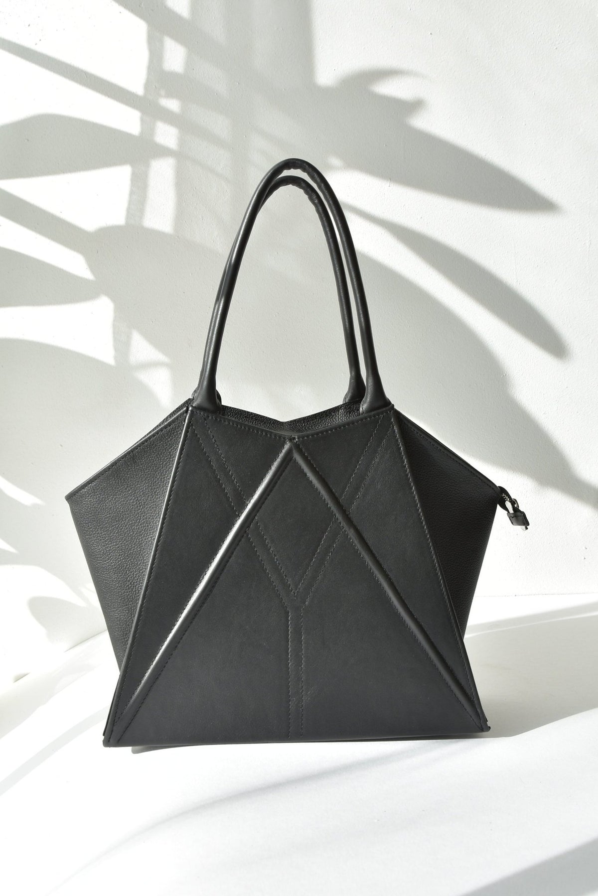 5. Studio shot of Gerda Retter Design Leather Handbag Nova in black, showcasing geometric design and handles
