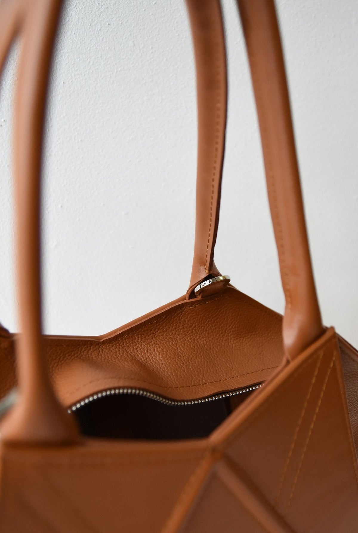 11. Close-up of the interior of Gerda Retter Design Leather Handbag Nova in caramel brown, showing magnetic closure